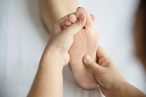 Hands massaging feet