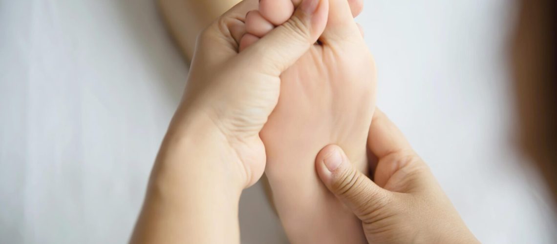 Hands massaging feet